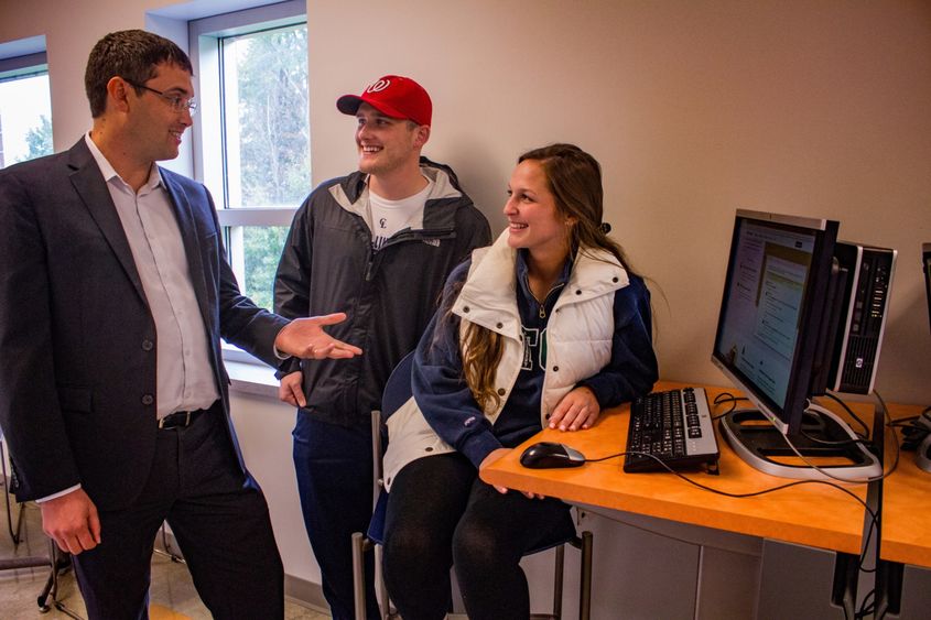 Matt Stanton, left, meets with students Brooks Bennett and Alex Bupp, both seniors.