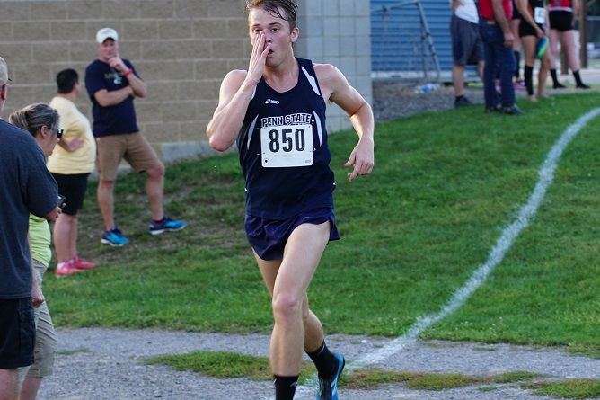 A Penn State Behrend cross country runner competes in a race.