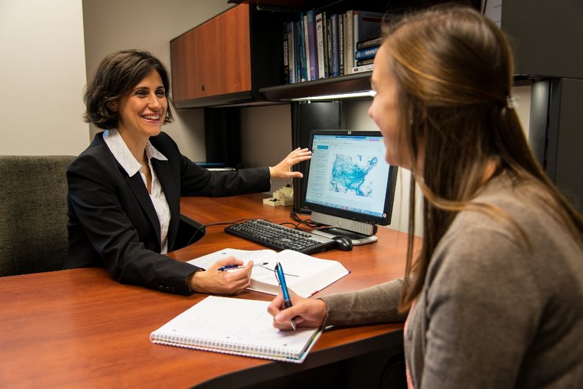A professor works with a student in the Penn State Behrend MBA program.