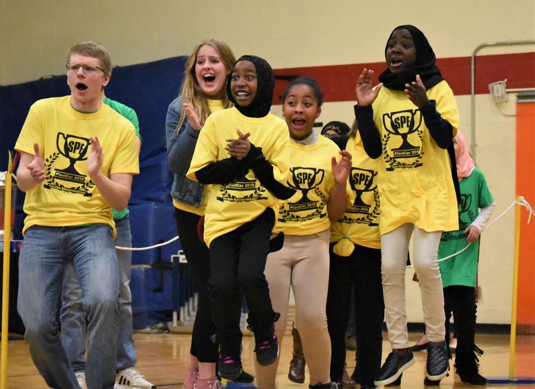 Pictured left to right, Matt Krause, Julie Lauris, Laila Abdirahman, Inihya Vaughn and Samira Babiker cheer on the unicorn ice cream truck during the 13th annual PLASTCar competition, held Dec. 11 at Penn State Behrend.