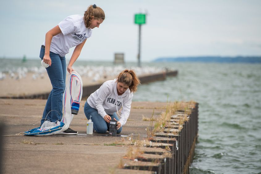 Two female students check a net after sampling Lake Erie for bloody red shrimp.