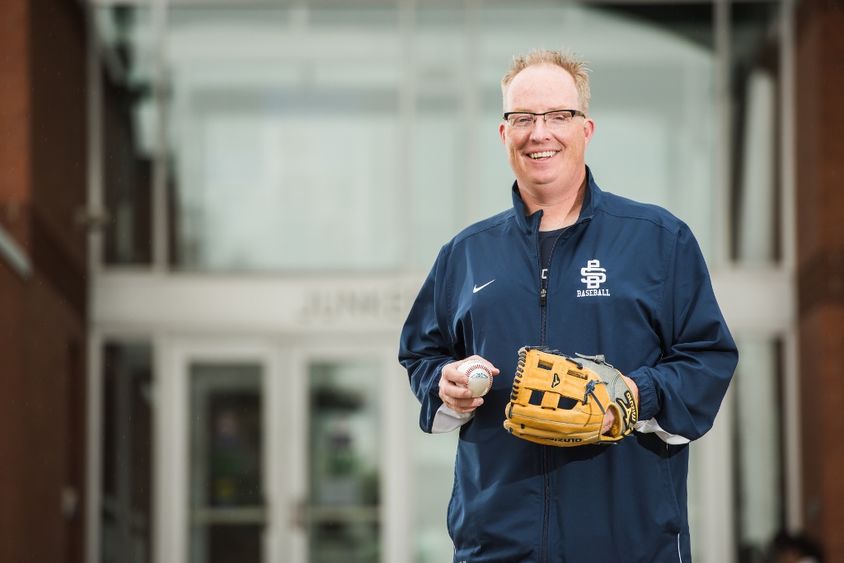 Penn State Behrend baseball coach Paul Benim stands outside the college's Junker Center.