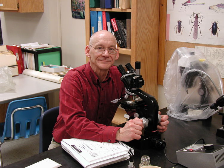 Penn State Behrend alumnus Peter Grant works at a microscope.