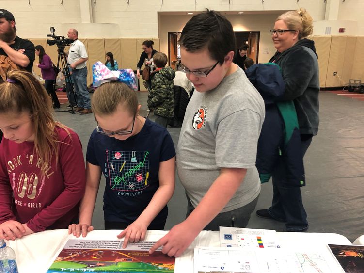 Gavin Williams, right, and Emma Williams work to build a cost-effective pipeline while the fifth-annual STEM Fair at Penn State Behrend.