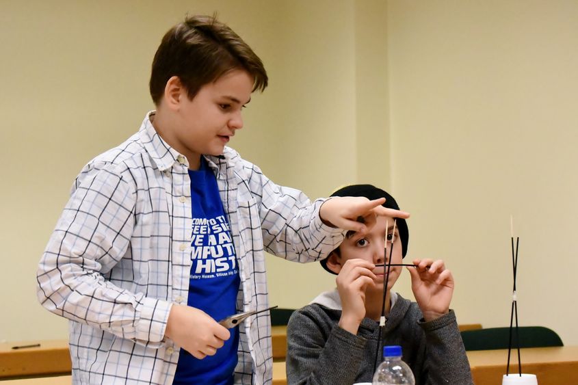 Ryker Selnekovic, left, and Killian Radel, both seventh-grade students in the Brookville Area School District, work to perfect their bridge during the Mystery Architecture activity at the 2019 regional Science Olympiad. 