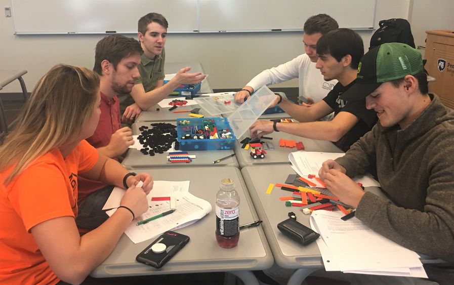 Students assemble Lego cars during a manufacturing simulation at Penn State Behrend.