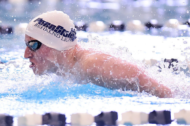 A Penn State Behrend swimmer competes in a race.