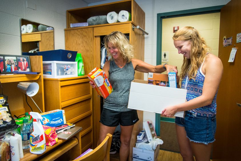A student and her mother unpack in a Penn State Behrend residence hall.