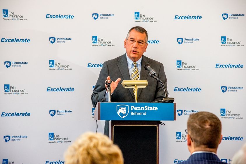 Erie Insurance Group President and CEO Tim NeCastro speaks at a podium during an announcement program for a new partnership with Penn State Behrend.