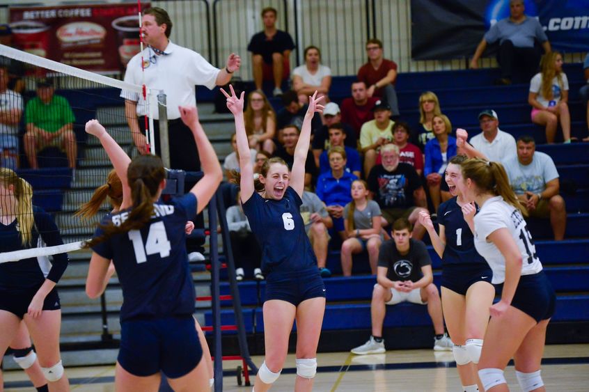 Members of the Penn State Behrend women's volleyball team celebrate a win.