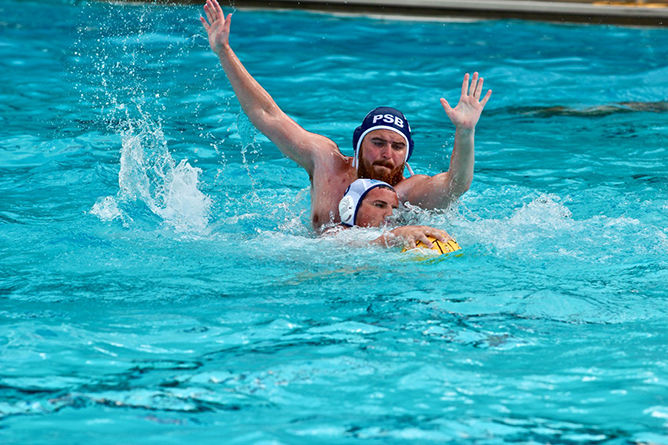 A Penn State Behrend water polo player battles for the ball.