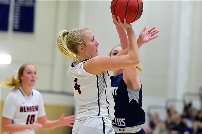 A Penn State Behrend basketball player shoots the ball.