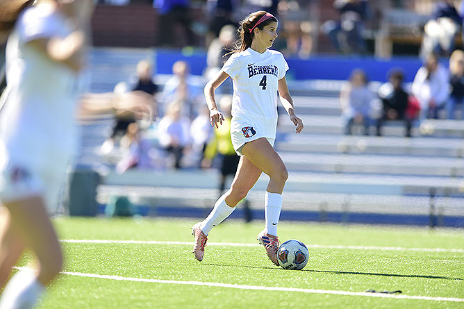 A Penn State Behrend soccer player kicks the ball.