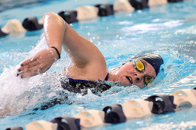 A Penn State Behrend swimmer competes in a freestyle race.