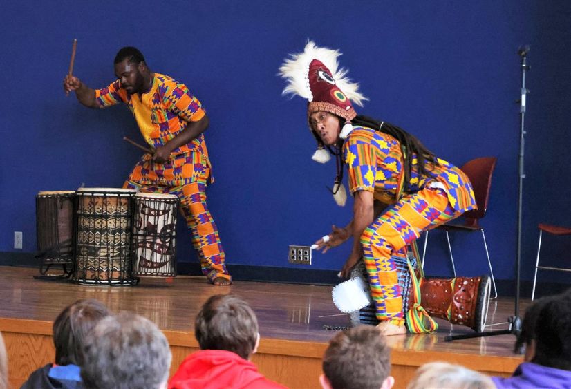 Two drummers perform traditional African music on a stage at Penn State Behrend's McGarvey Commons.