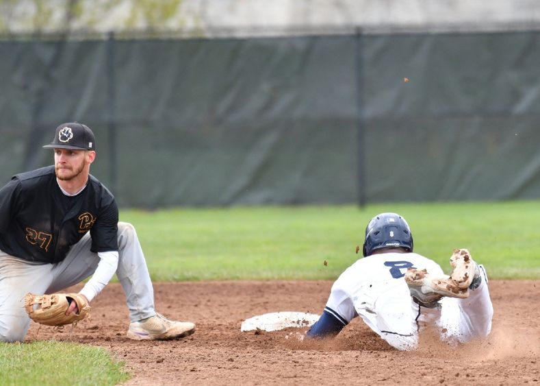 A Penn State Behrend baserunner slides toward a base.