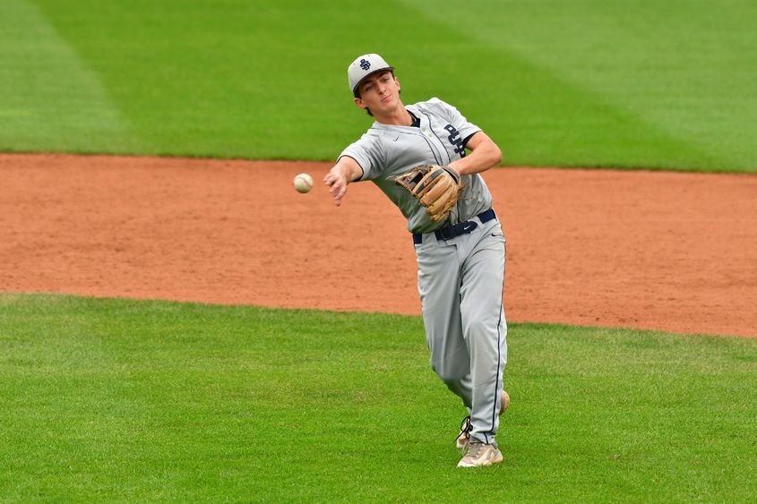 A Penn State Behrend infielder throws the ball.