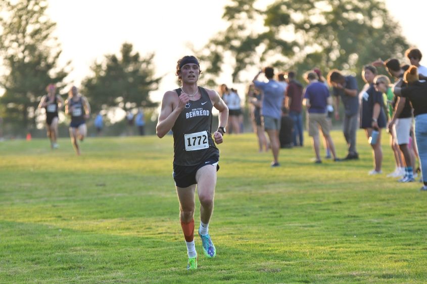 A Penn State Behrend runner competes in a cross country race.