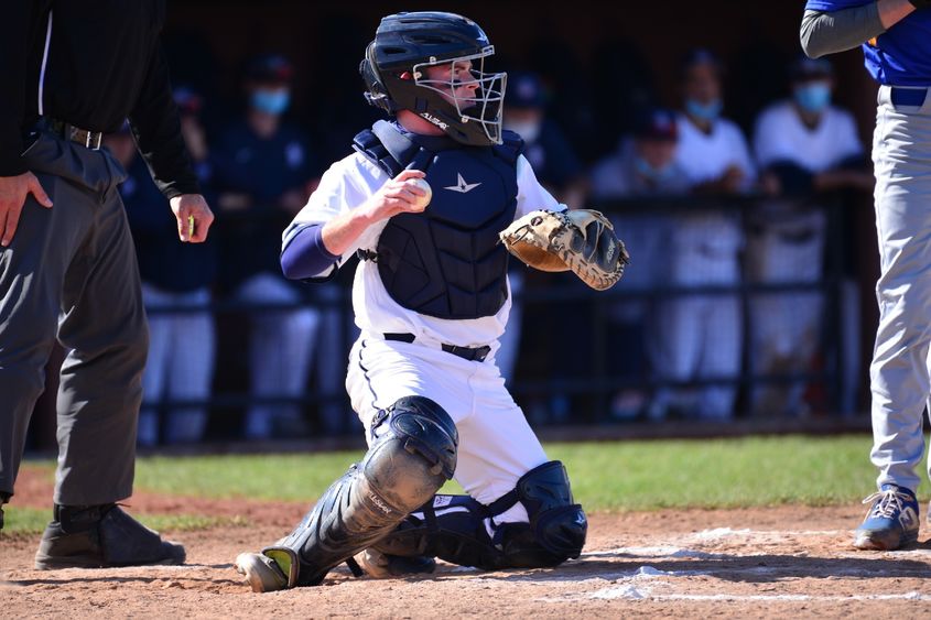 A catcher for the Penn State Behrend baseball team throws the ball.