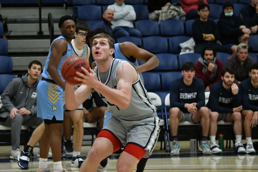 A Penn State Behrend basketball player prepares to shoot the ball.