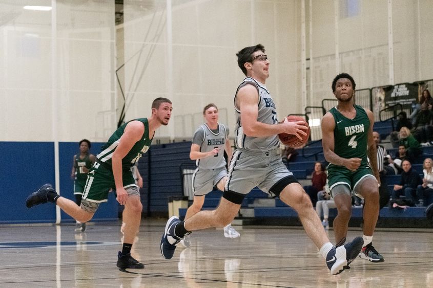 A Penn State Behrend basketball player prepares to take a layup.