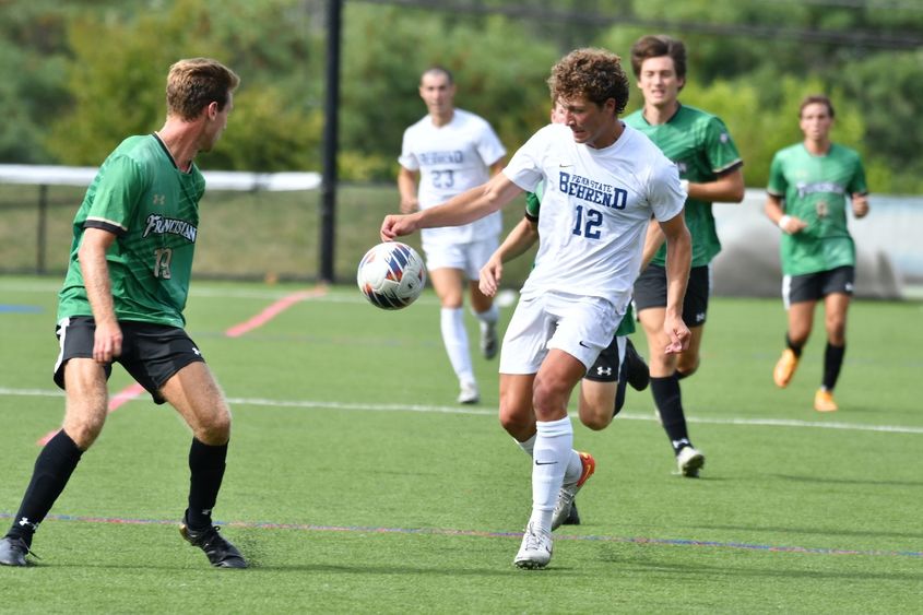 A member of the Penn State Behrend men's soccer team advances the ball during a game against Franciscan.