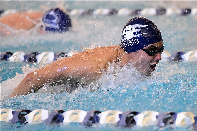 A Penn State Behrend swimmer competes in a butterfly event.