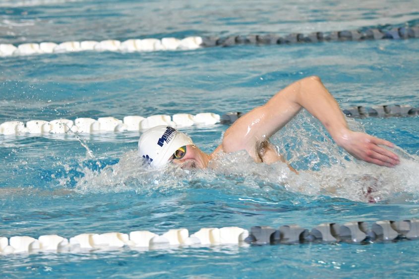 A Penn State Behrend swimmer competes in a freestyle event.