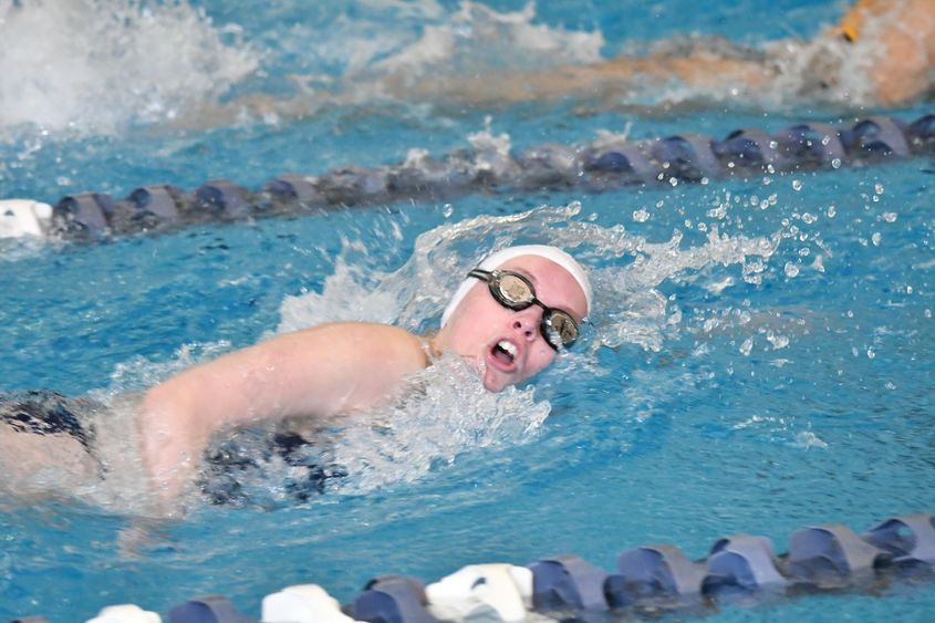 A Penn State Behrend swimmer competes in a freestyle event.