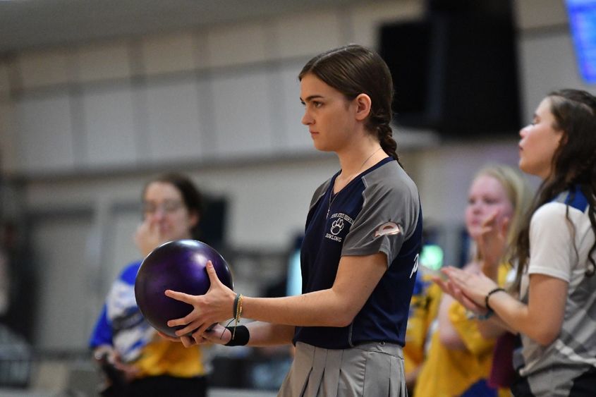 A member of the Penn State Behrend women's bowling team prepares to roll the ball.