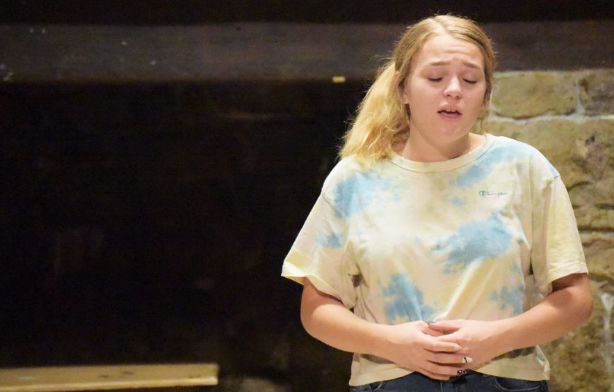 A female student sings during rehearsal for a musical theatre production at Penn State Behrend.