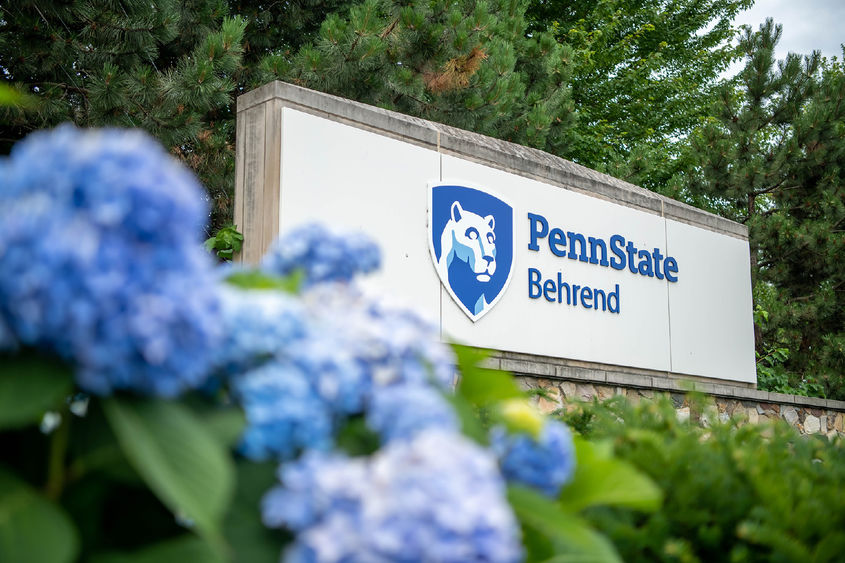 Flowers in front of the Penn State Behrend entrance sign