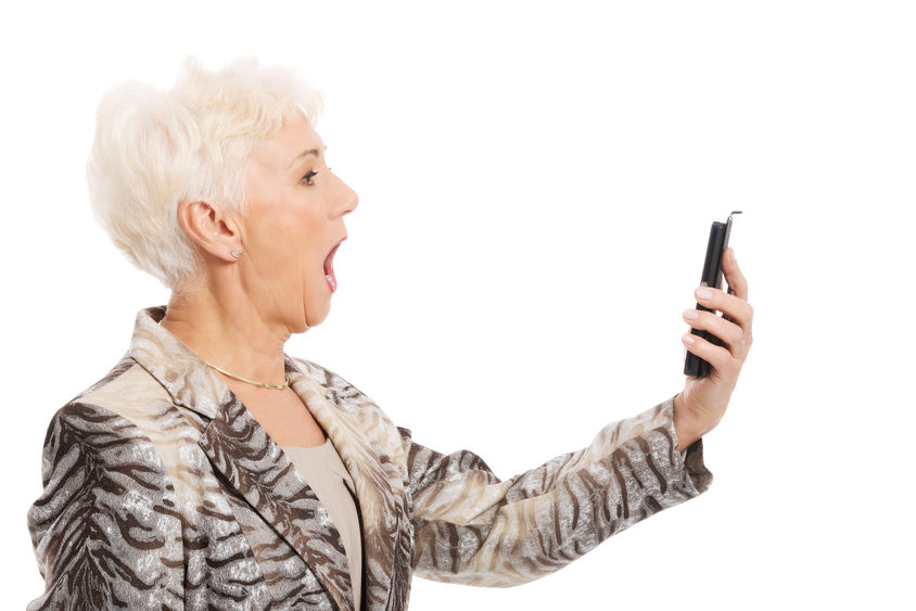 Image of an older woman looking at a phone.