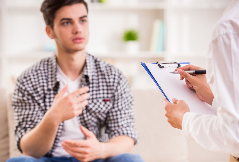 A counselor talks with a distressed patient.