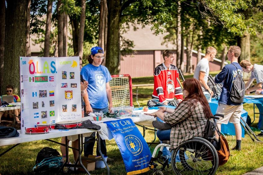 Members of a Penn State Behrend student group meet with potential members during the college's outdoor Club Showcase.