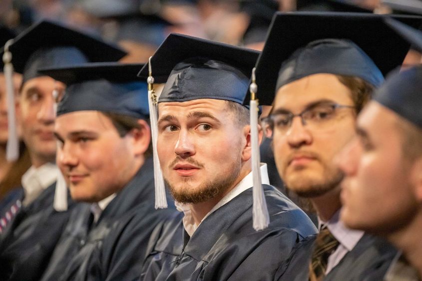 Students sit in a row during Penn State Behrend's spring commencement ceremony.