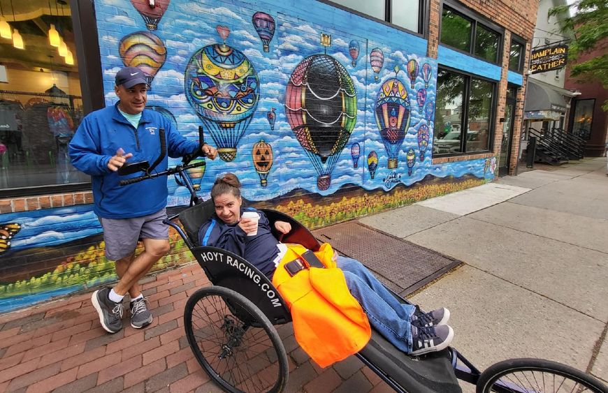Dan and Emma Perritano pose in front of a mural in Vermont.