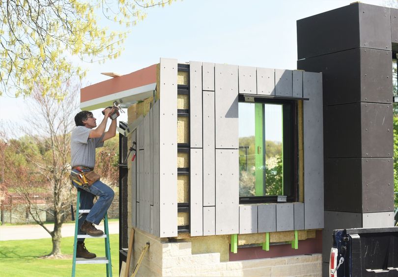 A contractor installs material on an architectural mockup at Penn State Behrend.