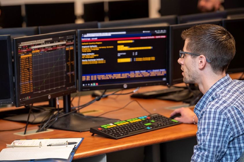 A student in Penn State Behrend's Black School of Business tracks a stock's performance on a Bloomberg Terminal.