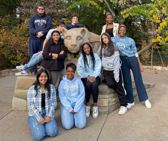 Ten students pose at Penn State's Nittany Lion shrine.