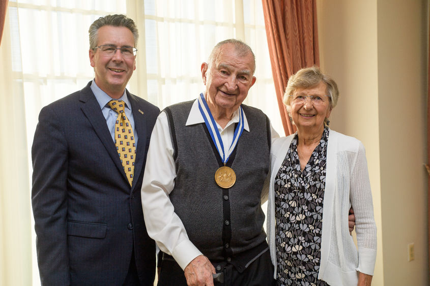Penn State Behrend Chancellor Ralph Ford presents the Behrend Medallion to Joe and Isabel Prischak