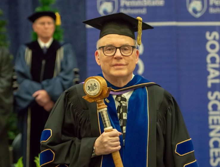 John Gamble John Gamble carries the Penn State Behrend mace during a college commencement program.
