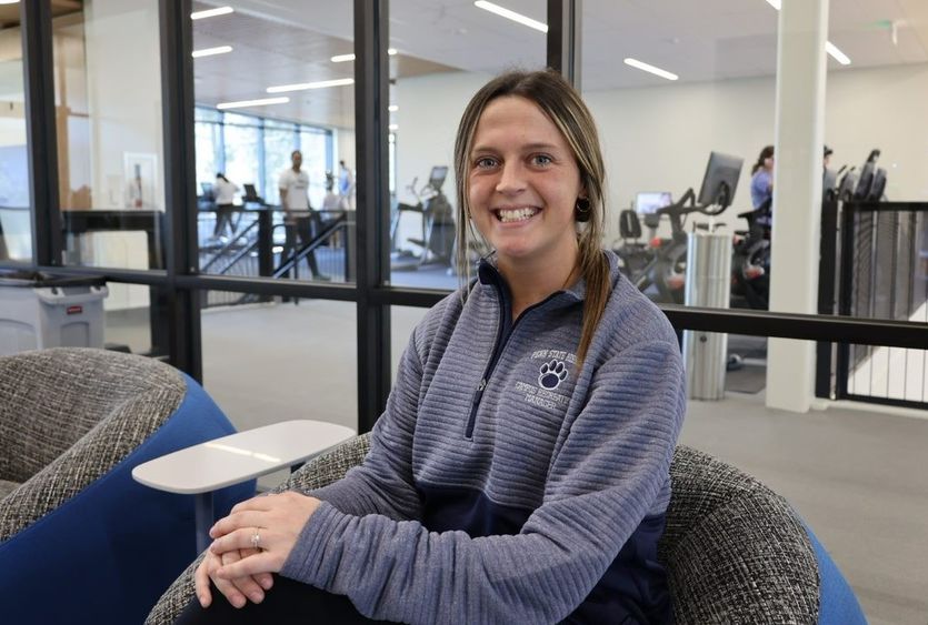 Kelly Wilson, the new campus recreation manager at Penn State Behrend, sits in the lobby of the college's new Erie Hall.