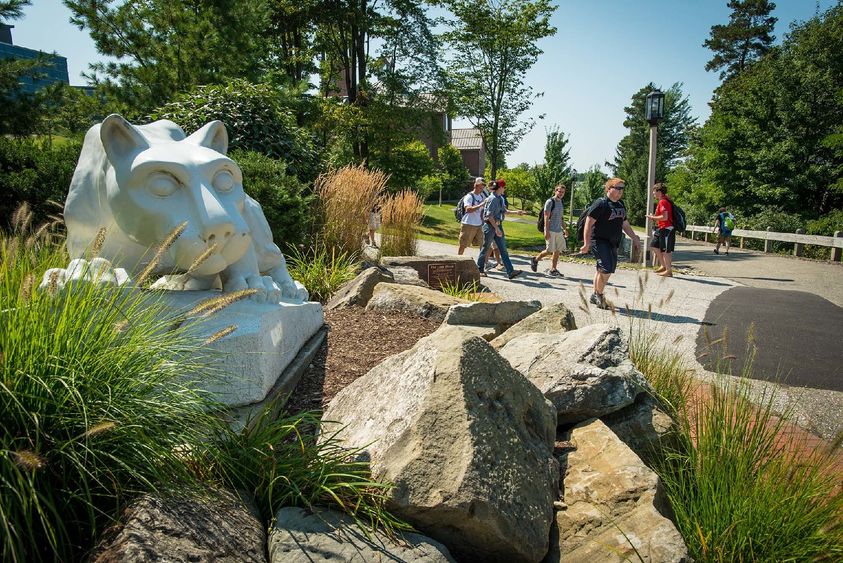 Students walk near the Nittany Lion shrine at Penn State Behrend