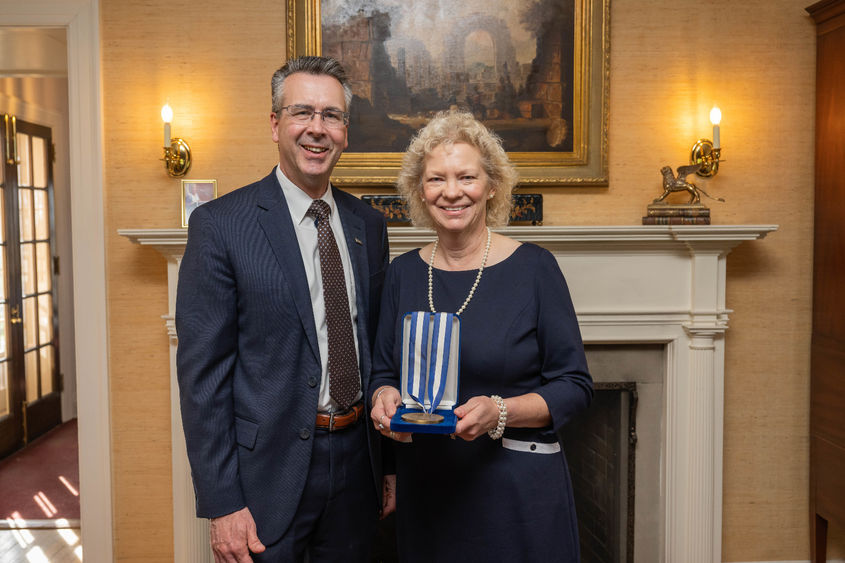 Penn State Behrend Chancellor Ralph Ford presents the Behrend Medallion to Nancy Anderson.