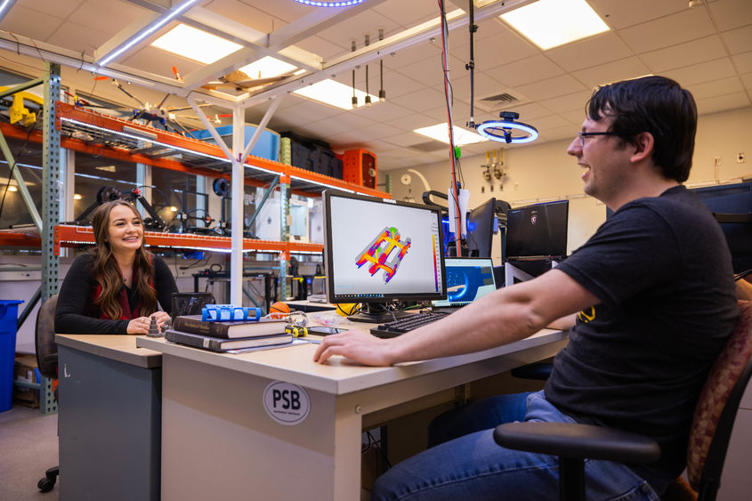 Two students work at a computer station in the Meehl Innovation Commons at Penn State Behrend.