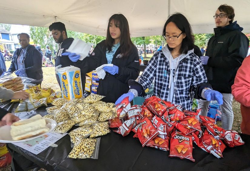 Penn State Behrend students serve food at the Our West Bayfront festival in Erie.