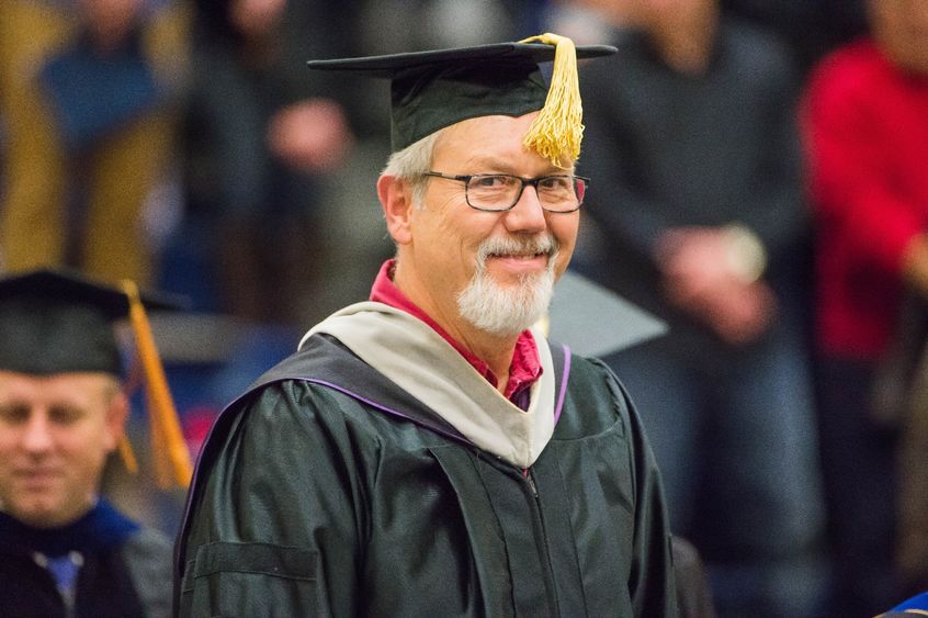 Rod Troester walks in the procession at a Penn State Behrend commencement ceremony.