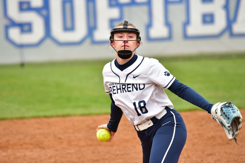 A pitcher for the Penn State Behrend softball team prepares to throw the ball.