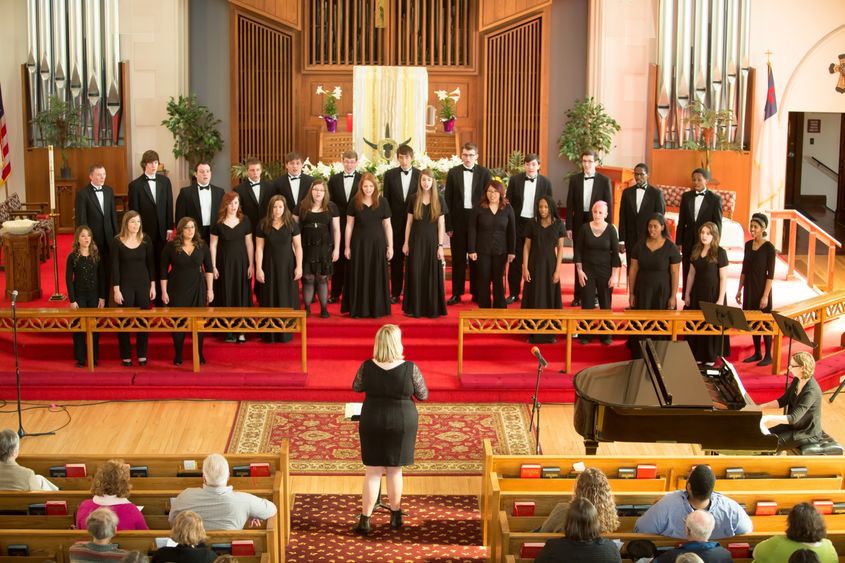 The Penn State Behrend choir sings in a church